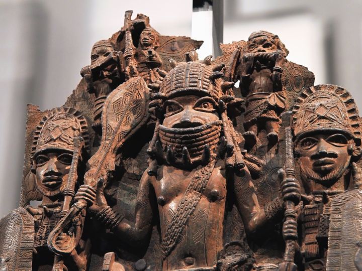 A cast brass plaque from Benin City showing figures of court officials in high relief
