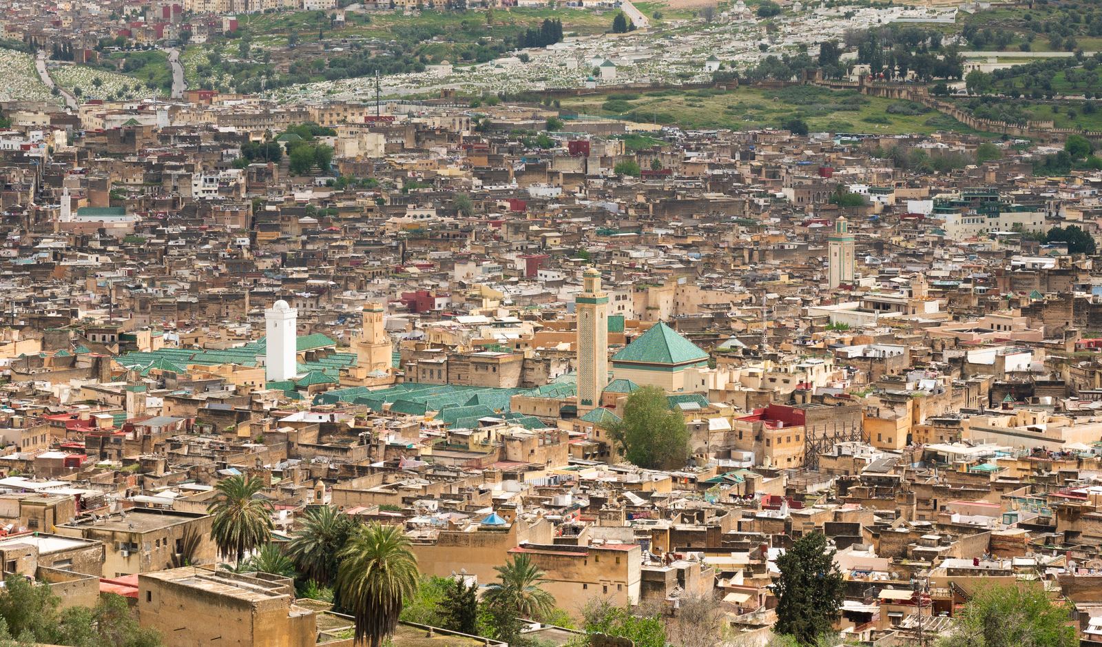 A wide view over the dense rooftops and minarets of the old medina of Fes, Morocco