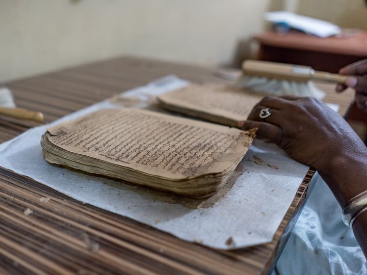 An open handwritten Arabic manuscript from Timbuktu with brown ink and decorated margins